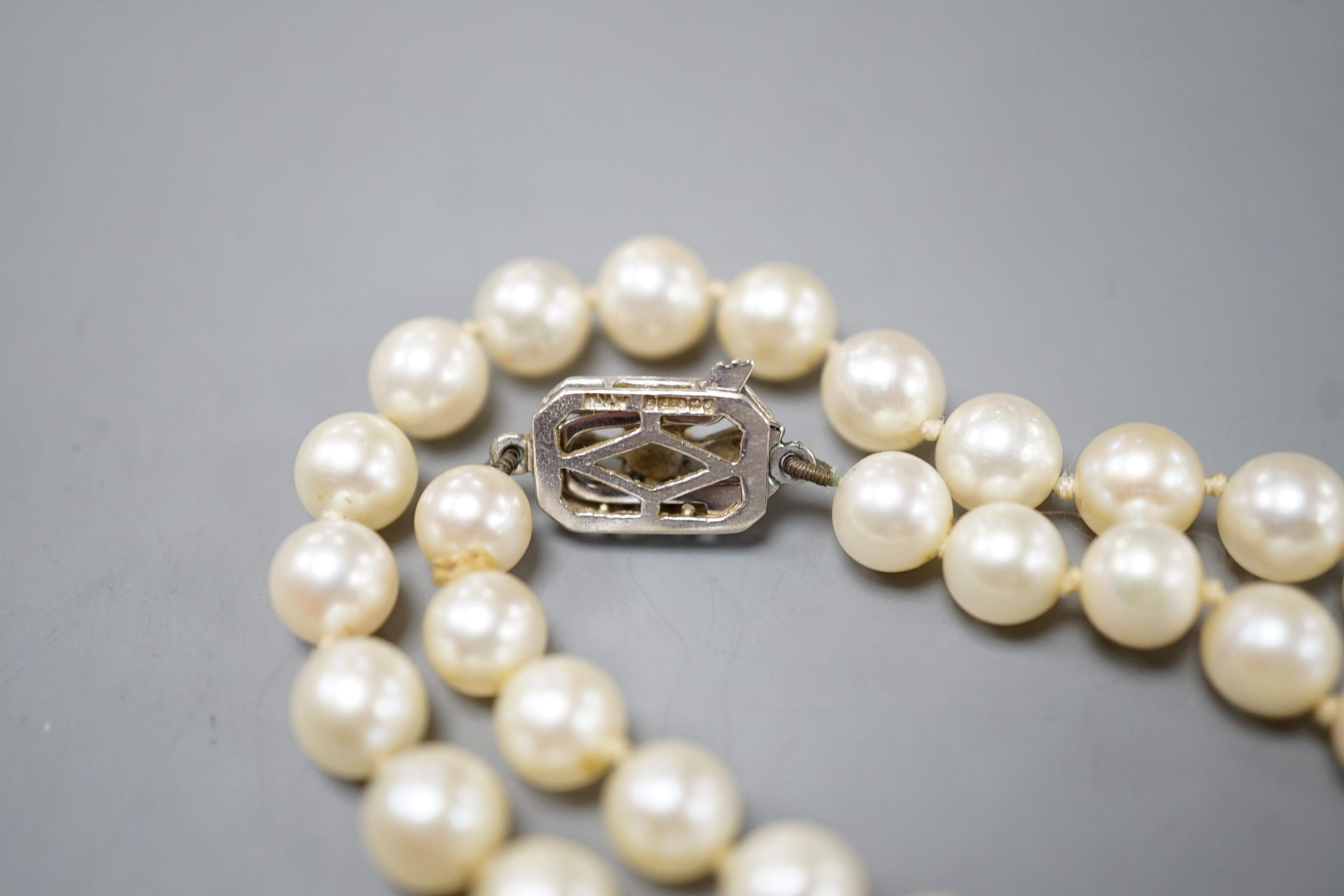 A long single strand cultured pearl necklace with cultured pearl set 9ct white gold clasp, 75cm.